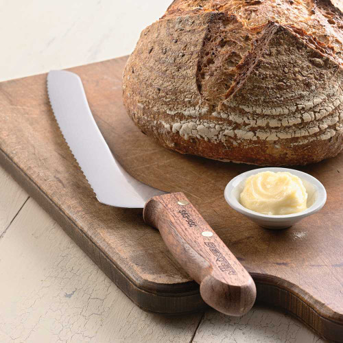 Offset Bread Knife on wooden cutting board with loaf of bread.